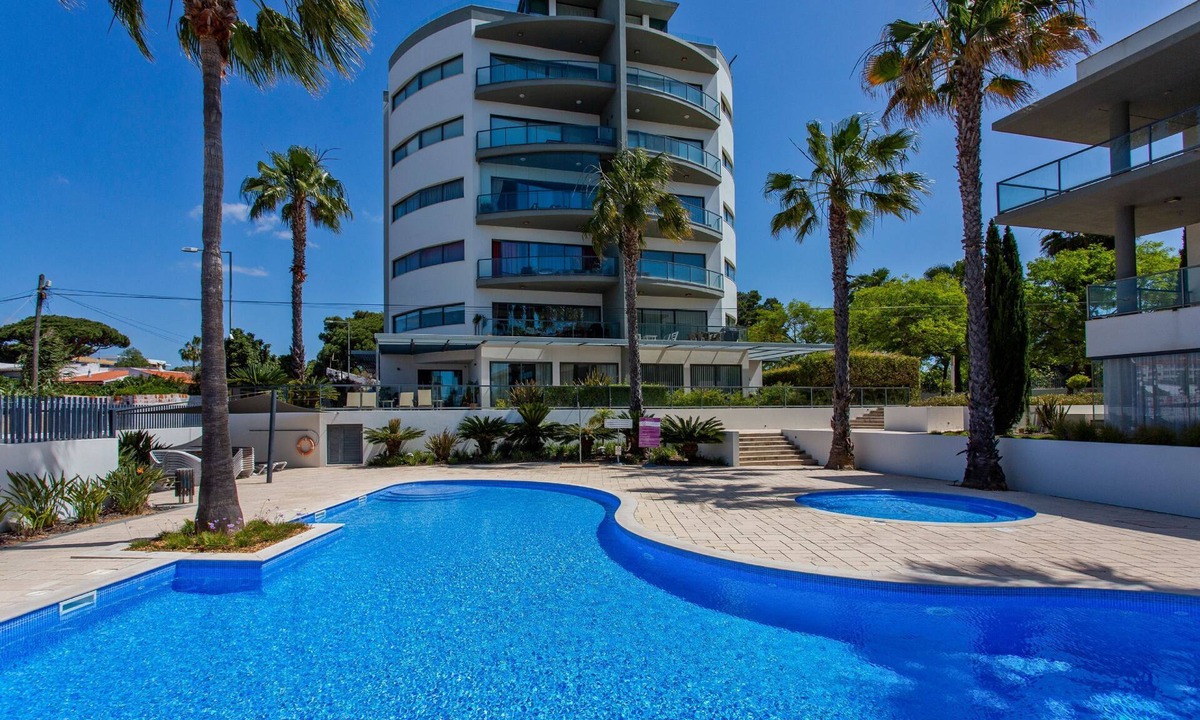 Quarteira Apartment | Relax by the pool at this Algarve apartment gem.