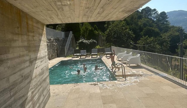 Quinta do Lodao, a renovated farmhouse on the banks of the Douro River with a swimming pool.